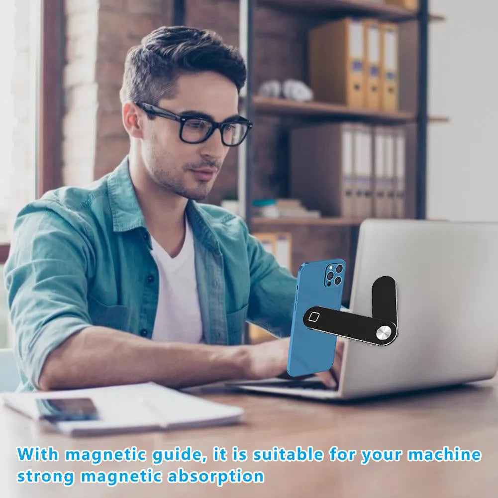 Black aluminium magnetic phone holder clipped to side of a silver laptop.