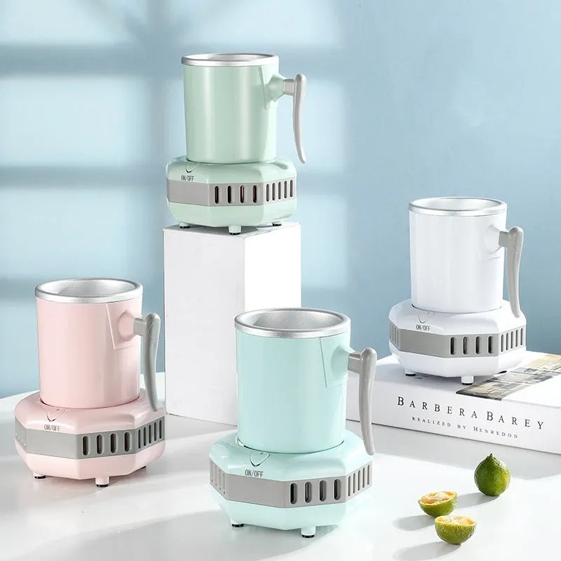 White portable mini cooling cup with aluminium drinking vessel and control base on a desk.