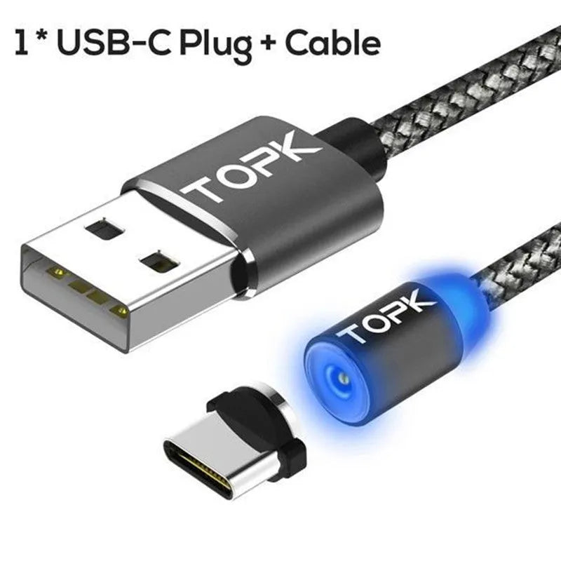 Magnetic charging cable with three adapter tips for Android, Apple and Type-C phones on a table.