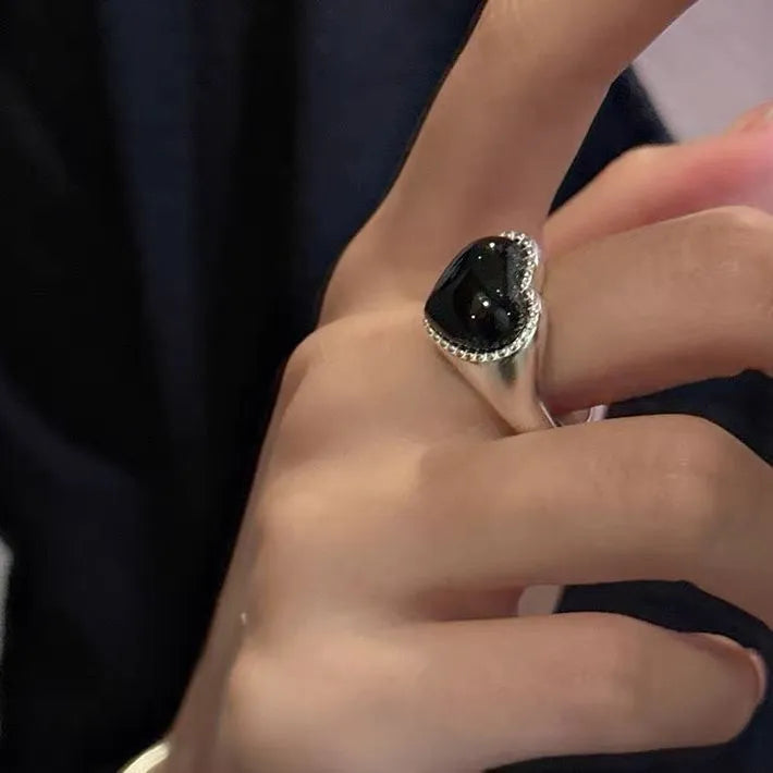 Sterling silver adjustable ring with black agate heart centrepiece on finger