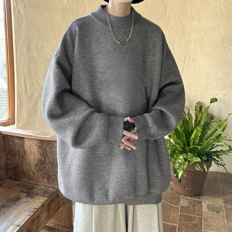 Men's loose fit round neck long sleeve sweater in a solid colour on a hanger.