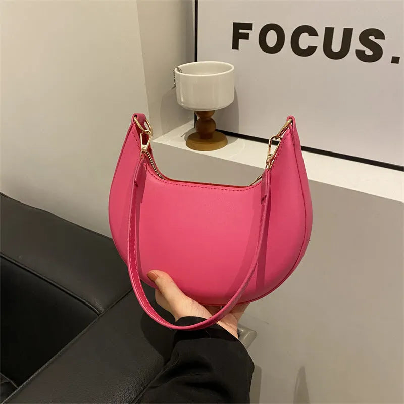 Round one-shoulder underarm bag in PU material, shown in green colour with visible sewing lines and a single strap.