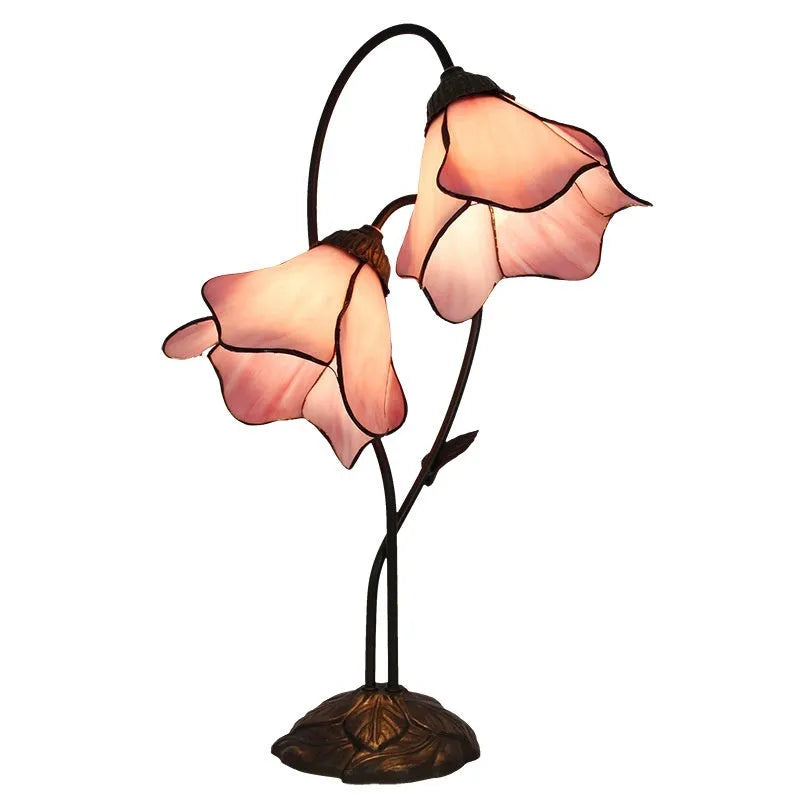 Retro American classical desk lamp with a decorative glass shade on a table.