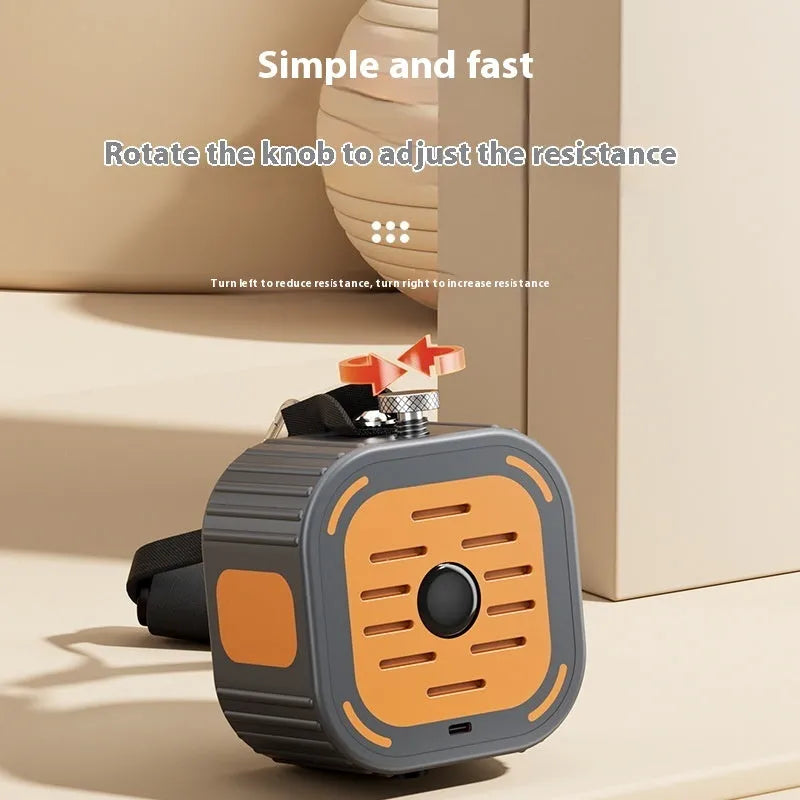 Navy blue and orange adjustable hydraulic chest expander pump on grey floor, showing ergonomic handles.