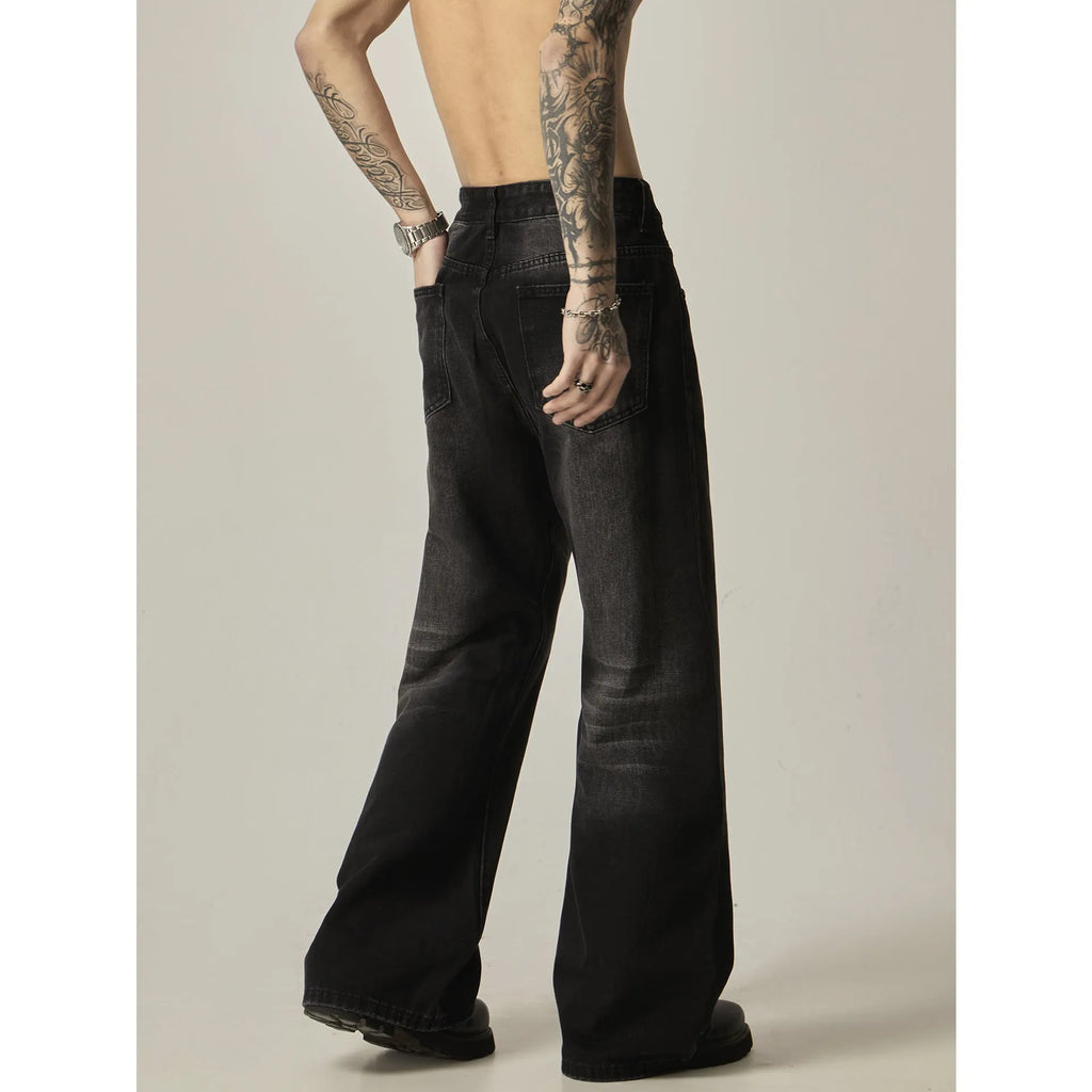Black straight-leg jeans with retro styling and loose fit on man