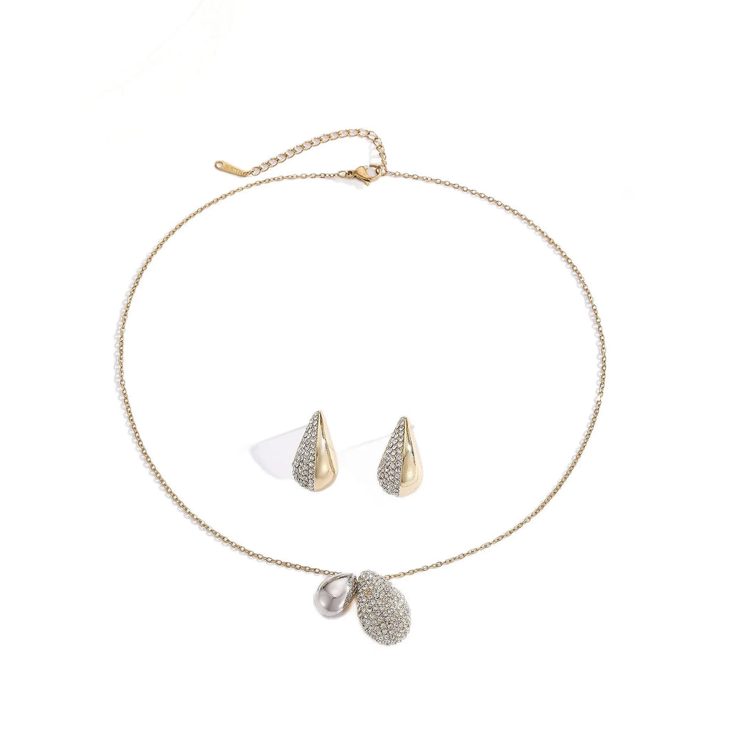 Elliptical necklace and earring set with full diamond droplet shape, silver-tone finish