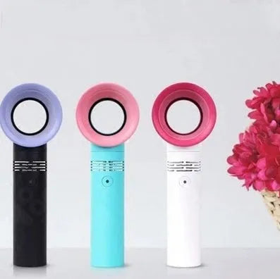 A compact portable bladeless fan with USB cable on a desk.