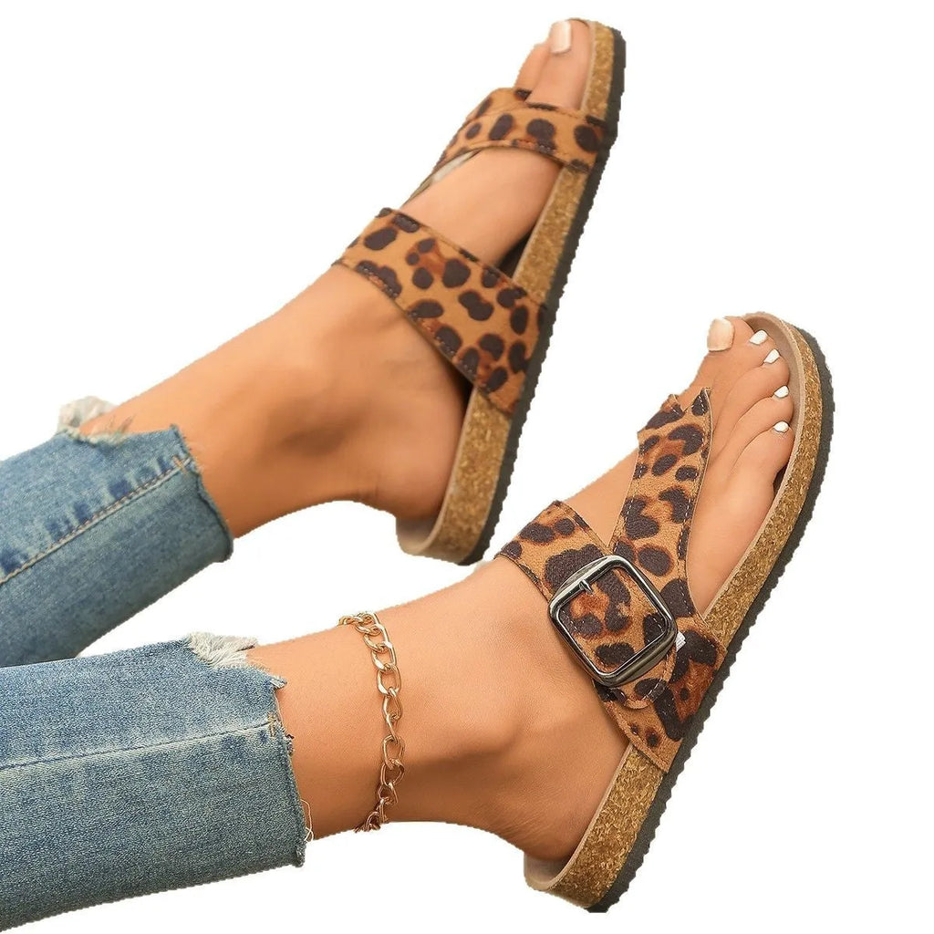 Leopard print Roman style slippers with rounded toe covering and wooden sole.