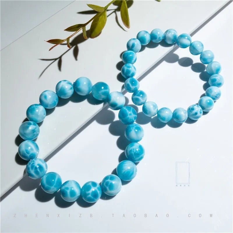 Blue handcrafted Bodhi bracelet with pearl accents, showing different bead size options.