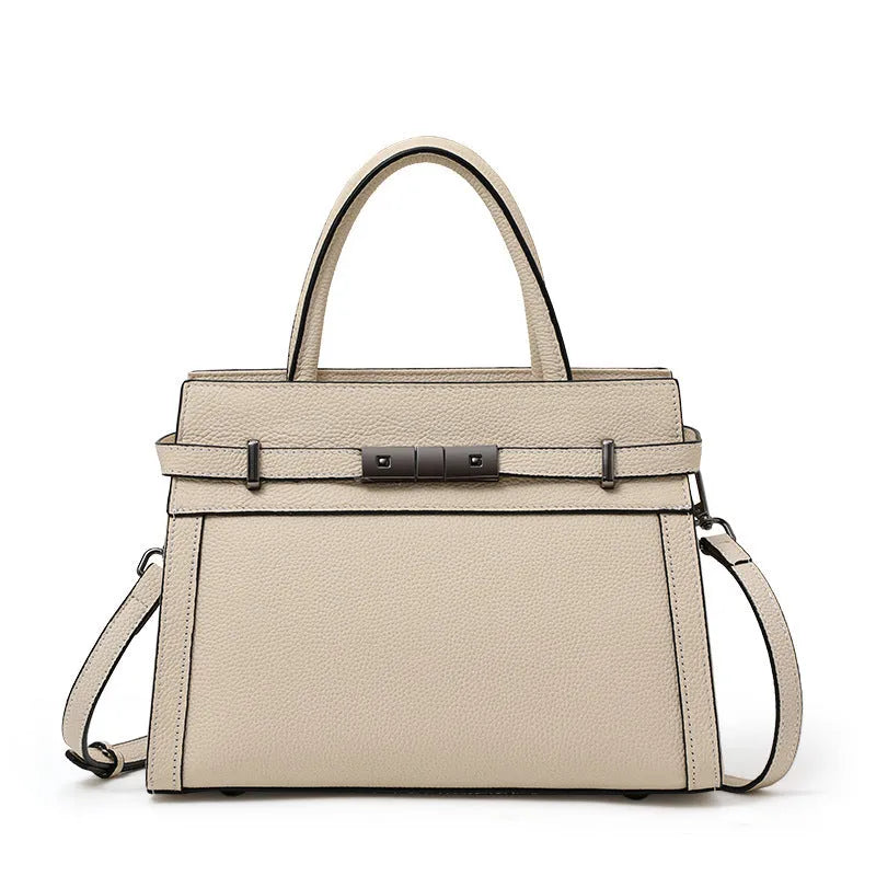 Women's black genuine leather crossbody clamshell handbag with multiple internal zip pockets.