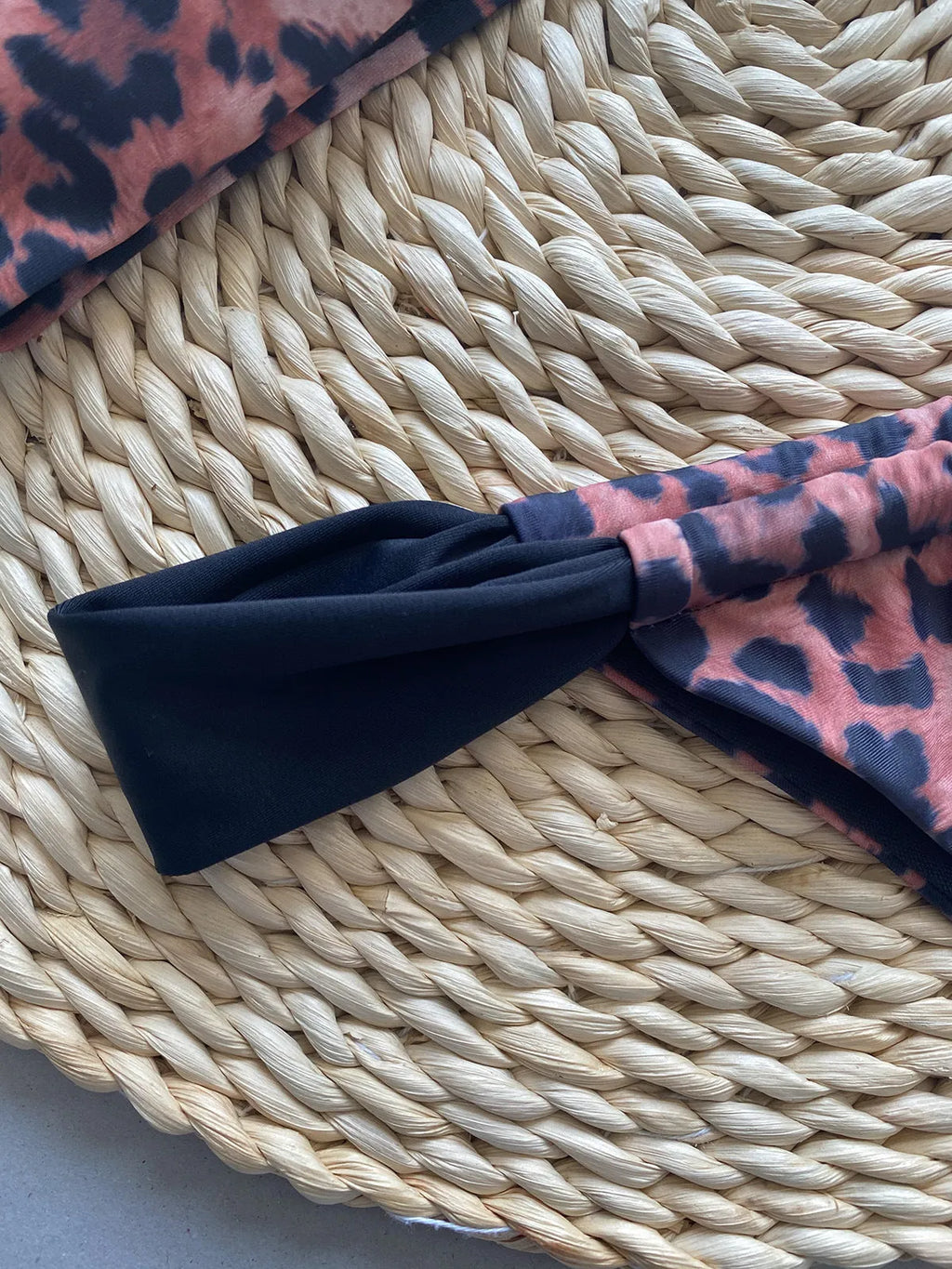 Leopard print women's bikini set showing sleeveless tube top and T-pants on a mannequin.