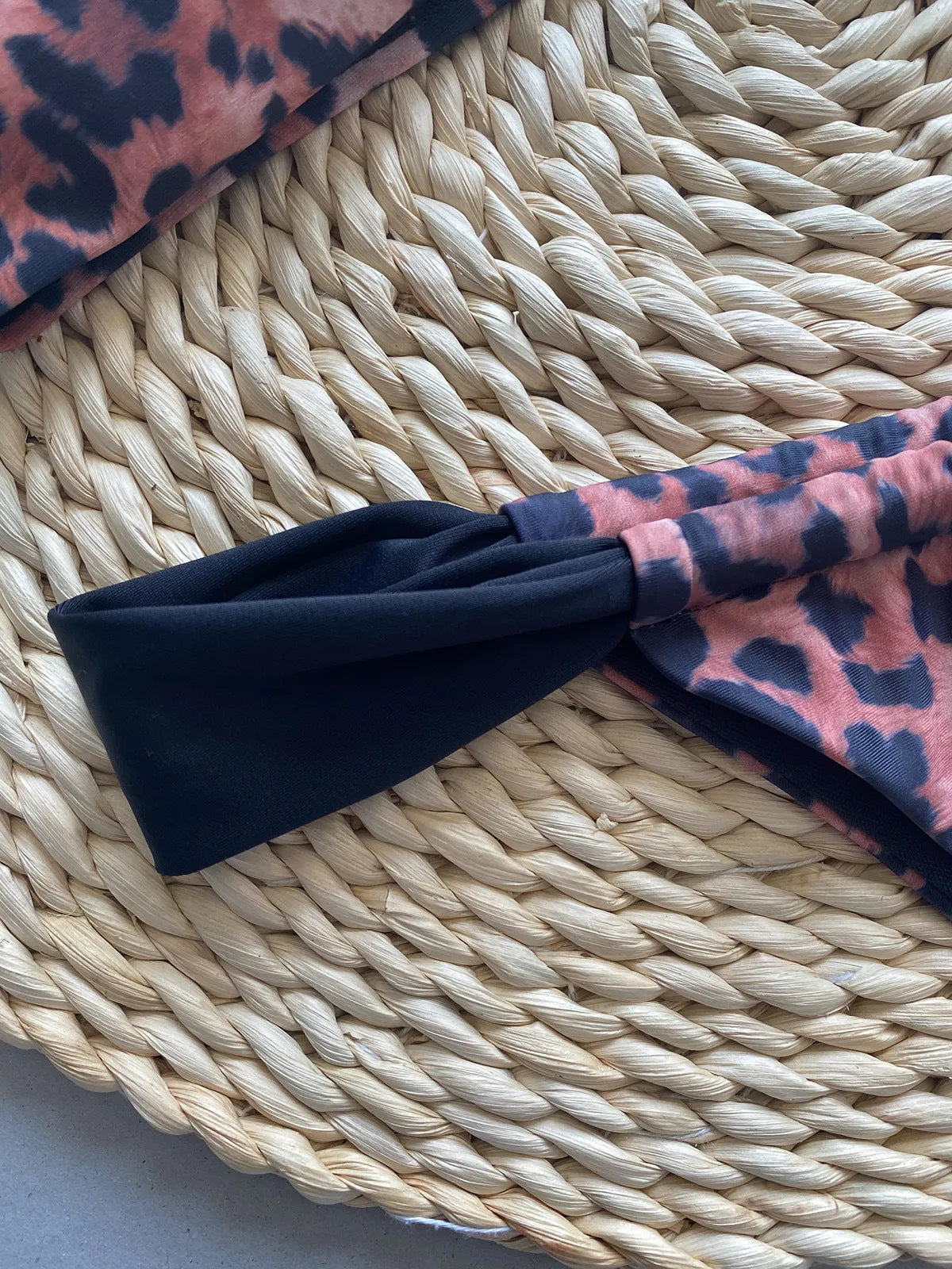 Leopard print women's bikini set showing sleeveless tube top and T-pants on a mannequin.