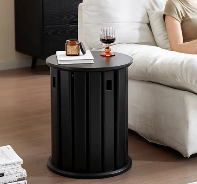 Set of four stackable iron dining stools with round seats in a modern design, shown in smoked black finish.
