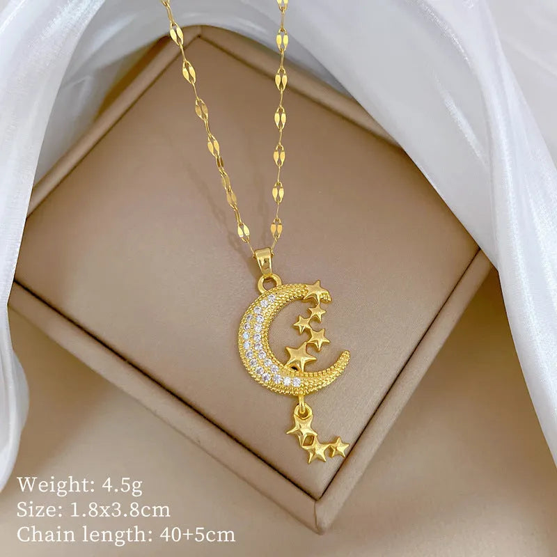 Geometric openwork moon pendant necklace with a linear crystal tassel on a silver stainless steel chain.