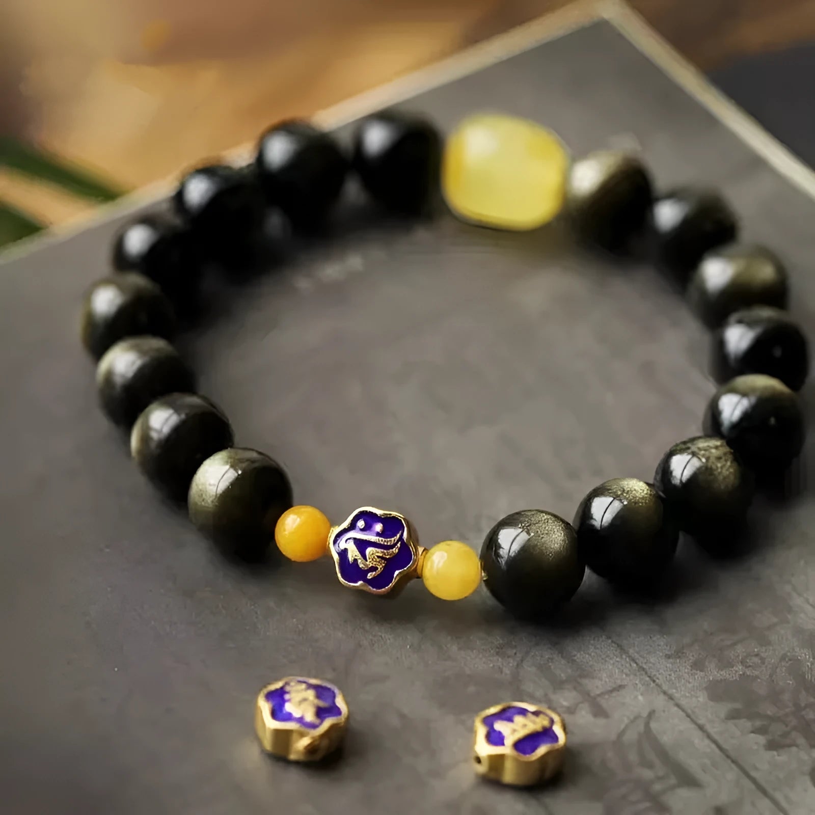 Golden obsidian ethnic bracelet with geometric shape and Chinese zodiac animal charm