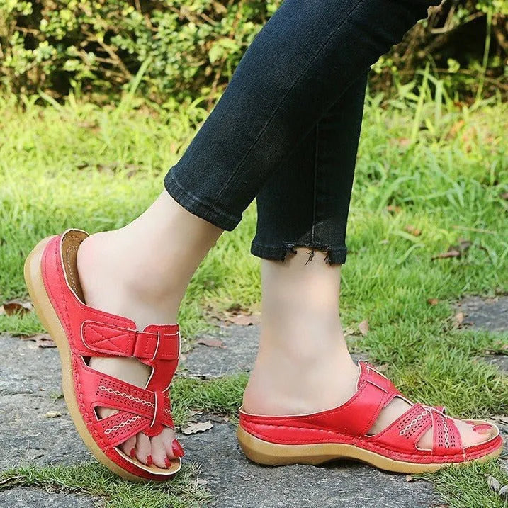 Women's red peep toe wedge sandals with a velcro strap closure on a fish mouth hollow wedge heel.