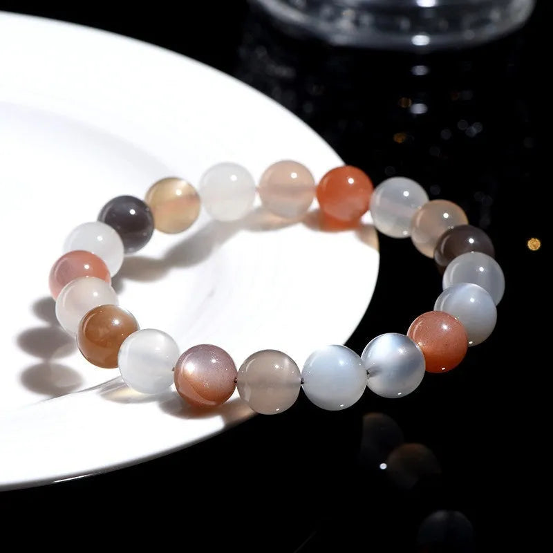 Natural colourful moonlight moonstone bracelet with 8mm single circle beads on a wrist.