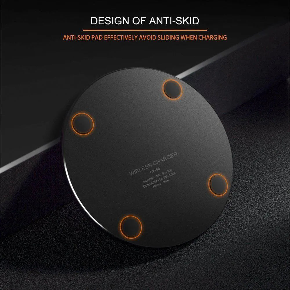 Black square wireless charging pad on desk with smartphone charging wirelessly