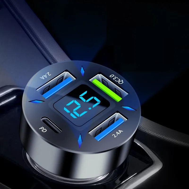 Black four-port USB car charger with LED digital display showing voltage.