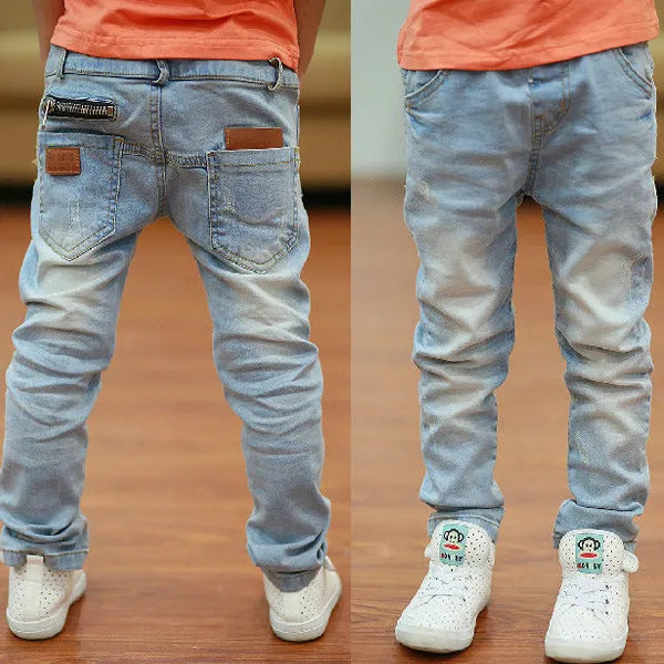 Boys' striped denim harem trousers with an elasticated waistband on a hanger.
