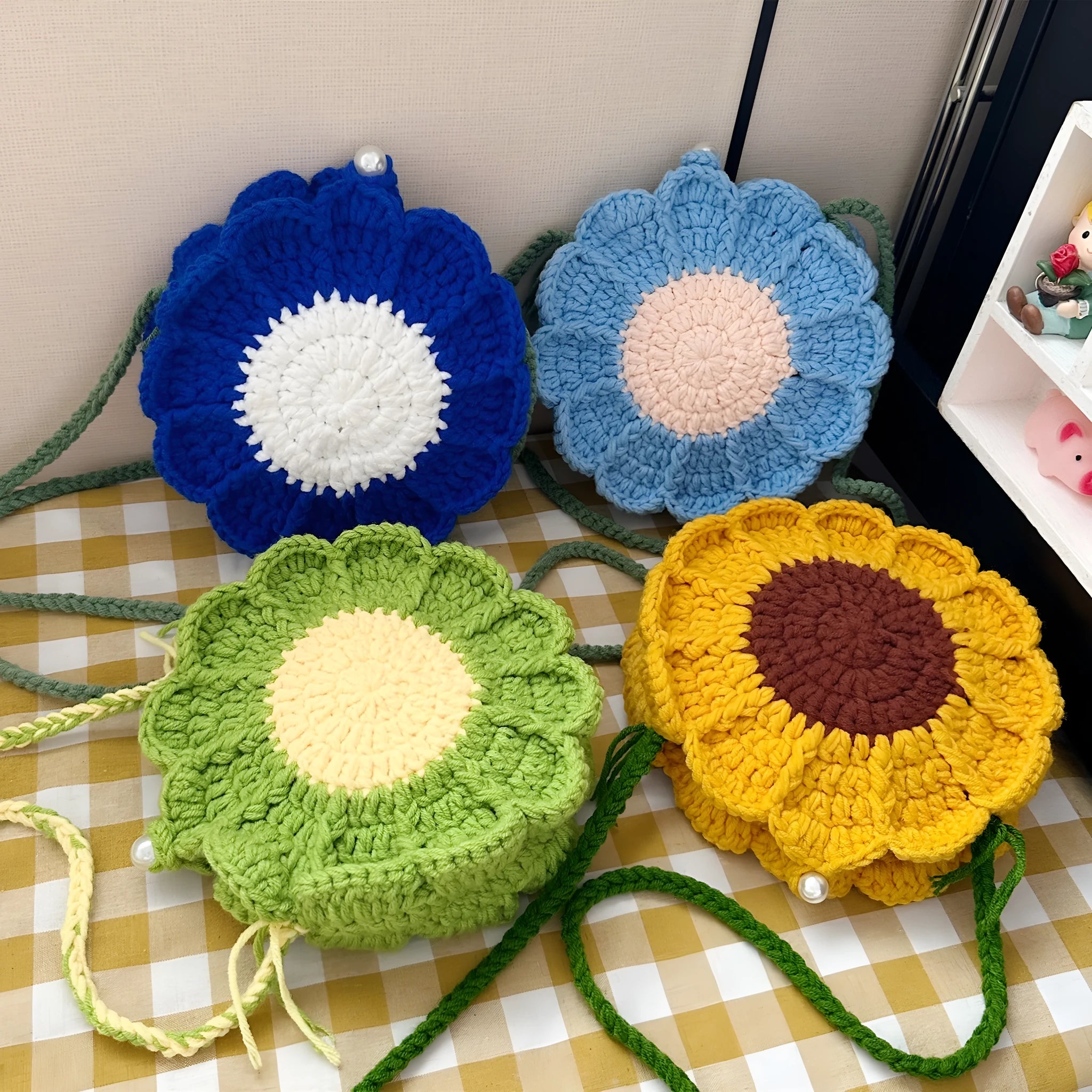 Round hand-woven bag with crocheted wool flowers and mobile phone pocket