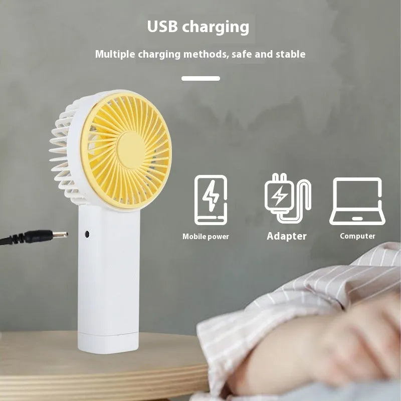 Outdoor portable USB rechargeable handheld fan in pink with plastic blades and brushed motor