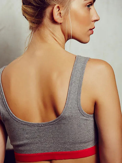 Solid colour polyester fibre sports bra in Black, Grey, Pink, or White for gym and yoga support