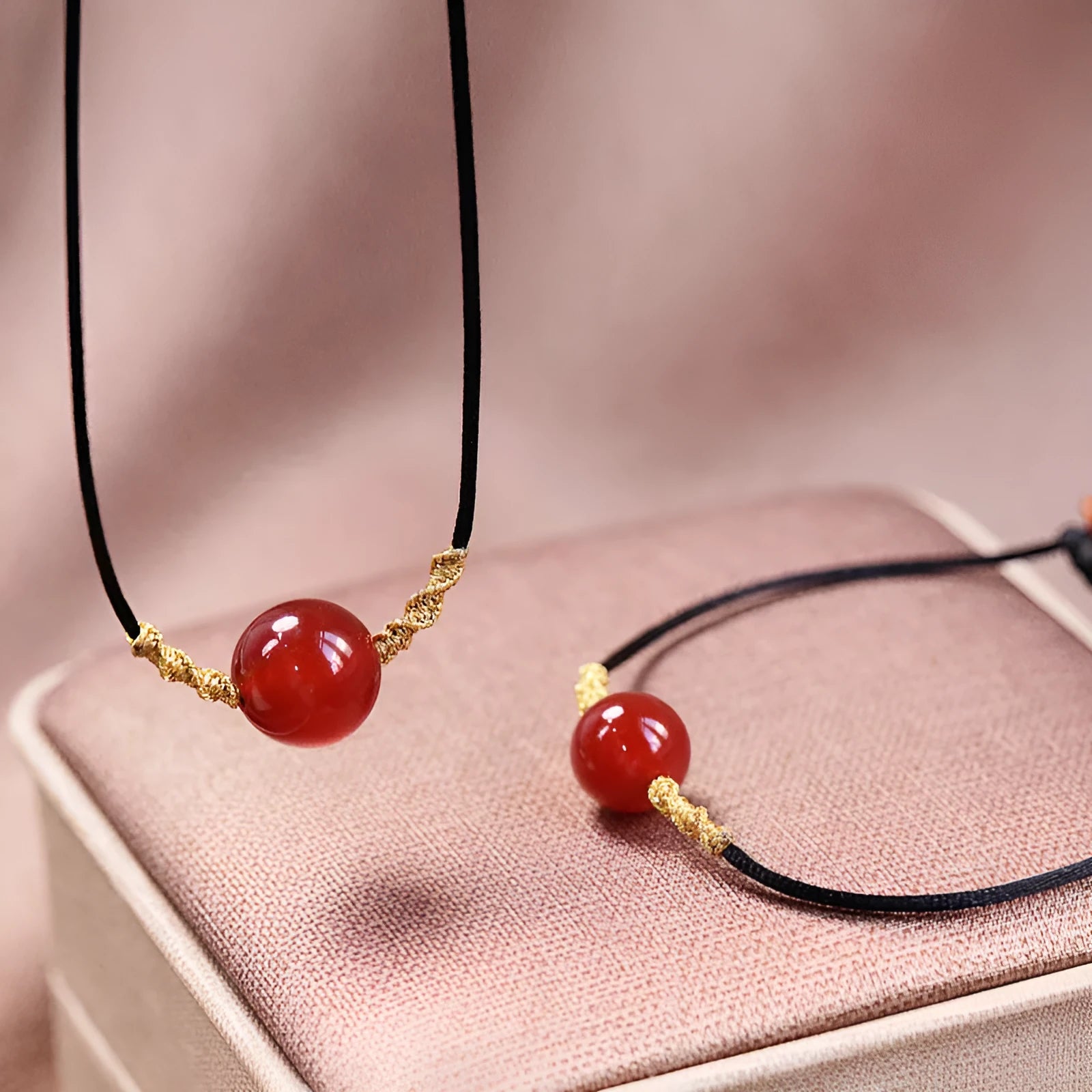 A natural red agate bead bracelet and necklace set with hand-woven detailing.