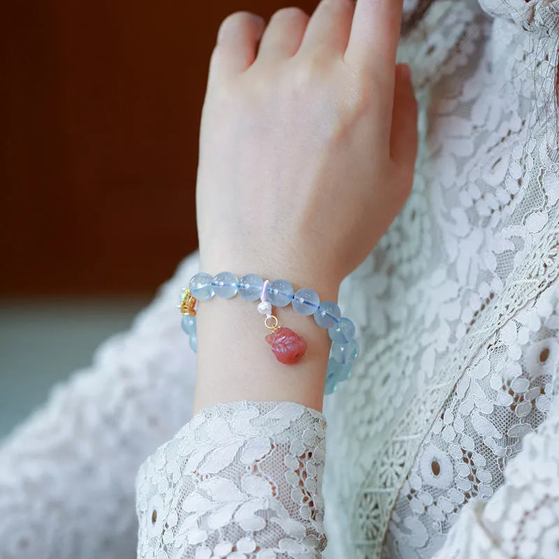 DIY adjustable aquamarine bead bracelet with pearl accents and a Chinese style fox Fengjiu charm.