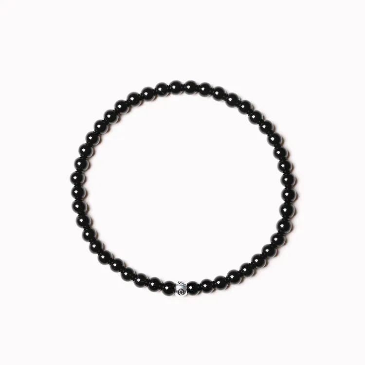 Geometric stone bead bracelet with black agate, blue san, obsidian, and cut surface black agate in chamfered square shapes