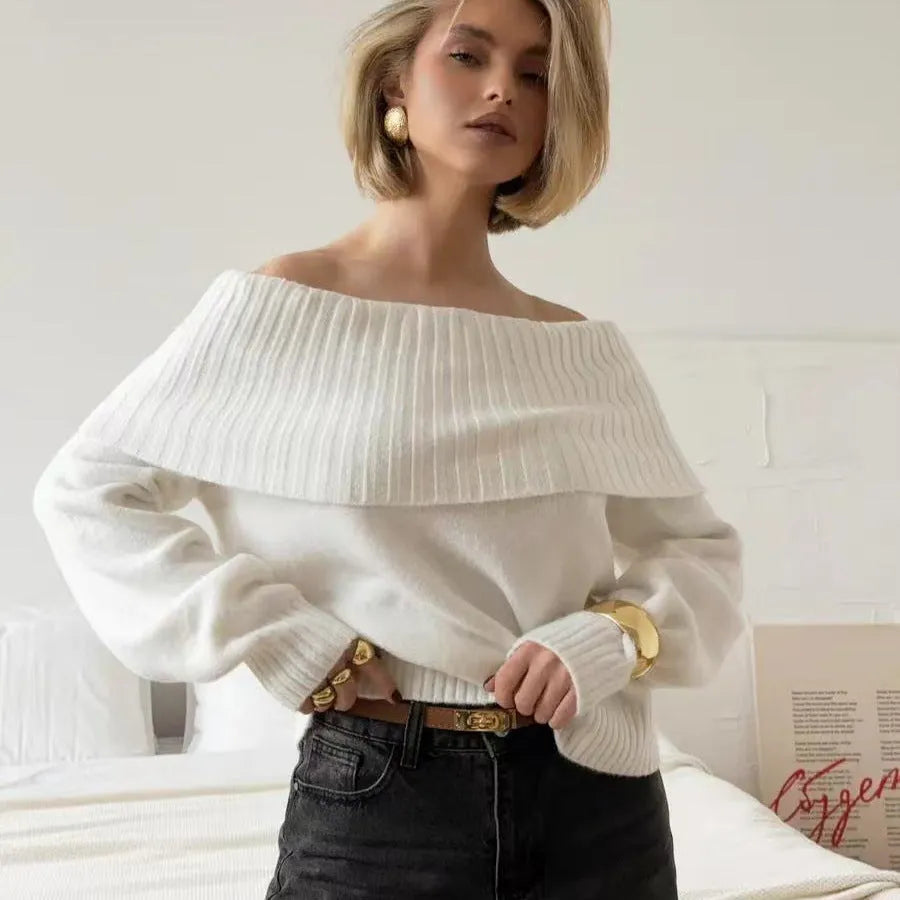 Grey off-the-shoulder sweater with a 3D pattern texture on the fabric.