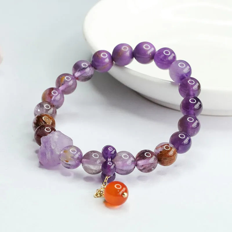 Nine purple fire amethyst bracelet with red agate accents in Mori style design