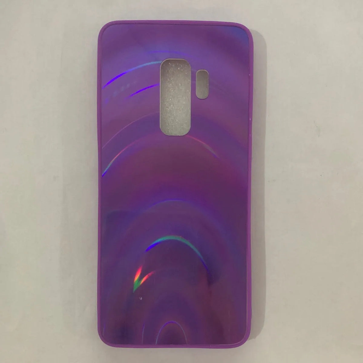 A 3D rainbow glitter gradient back cover case for a smartphone, showing its full-coverage design and sparkling finish.