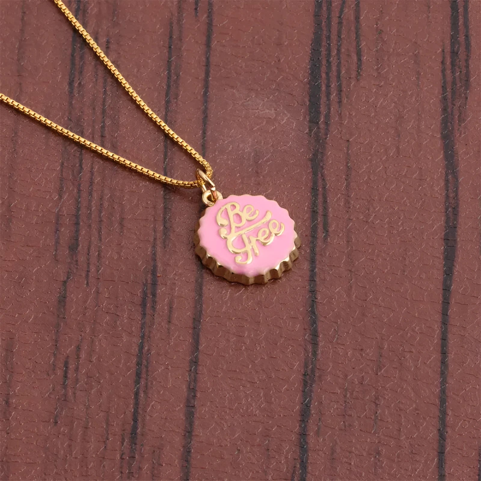 Copper bottle cap pendant necklace with 18K gold plating on a 40 cm box chain.