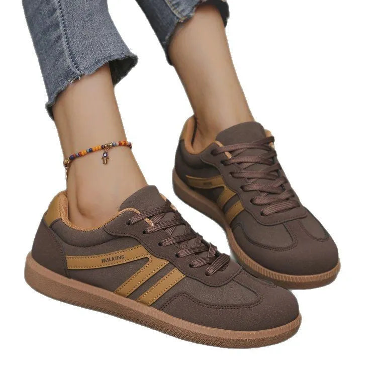 Women's low top casual sneaker in retro style with round toe and lace-up front.