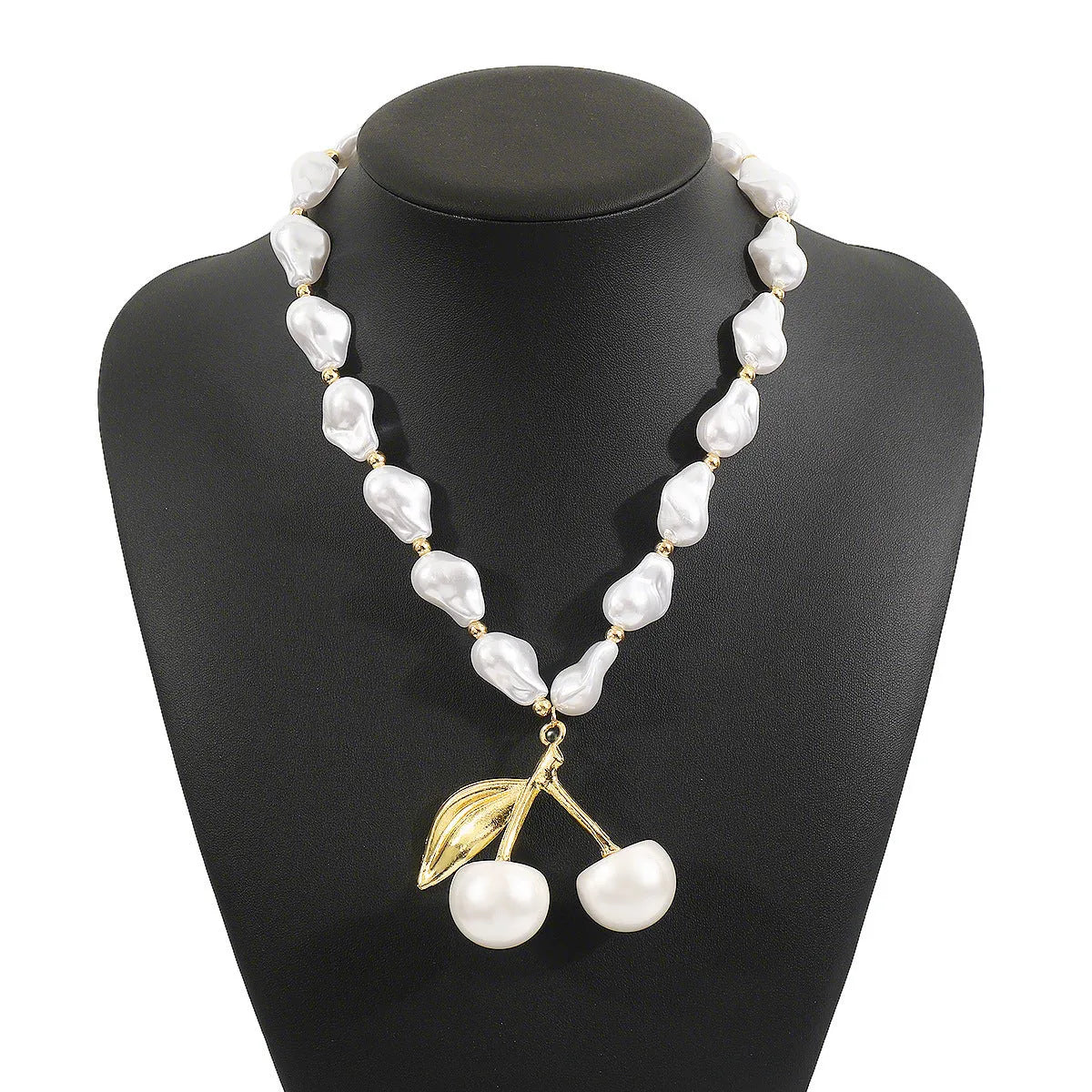 Gold-tone adjustable necklace with imitation pearls and cherry fruit pendants on a white background.