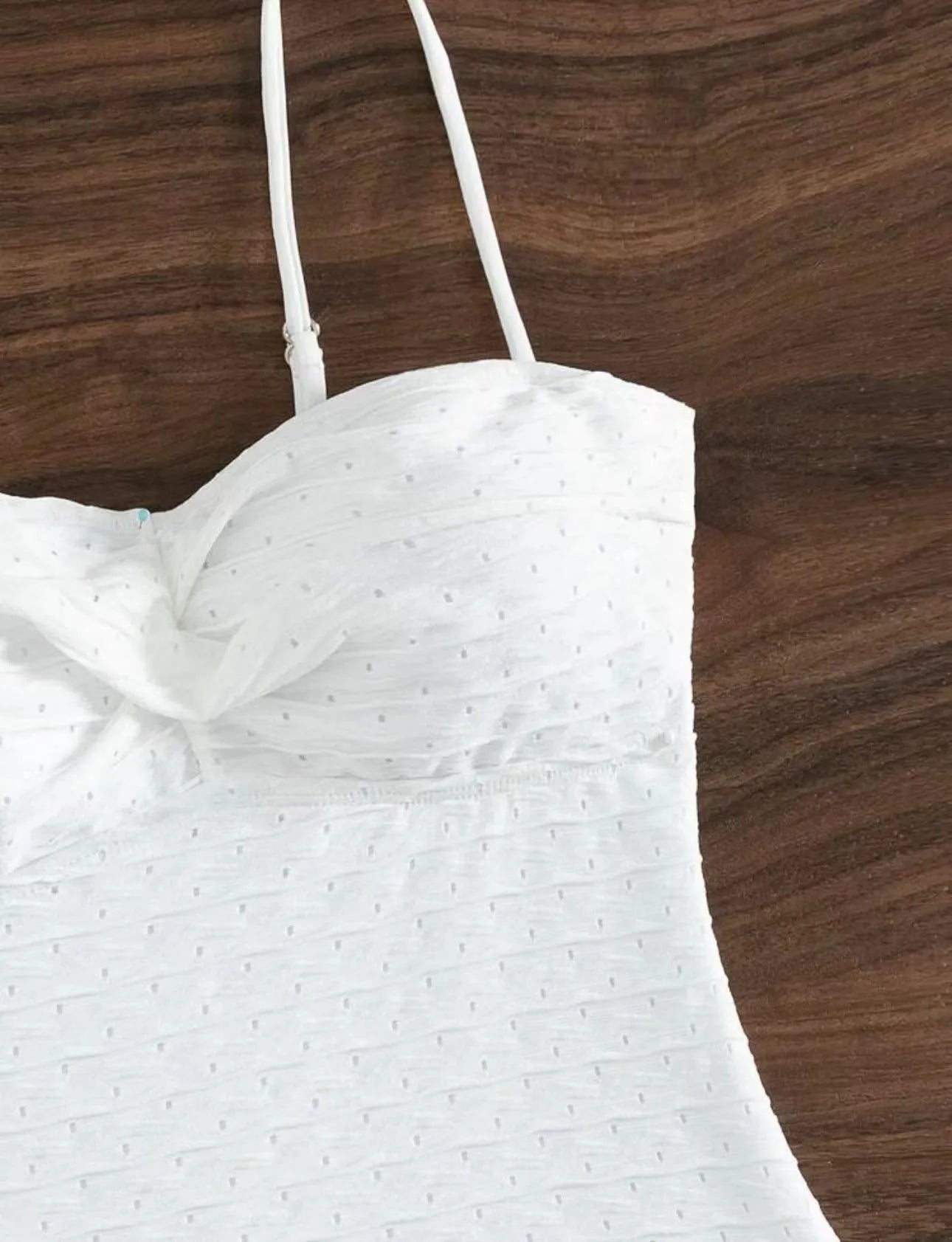 White sling-style one-piece swimsuit for women on a mannequin