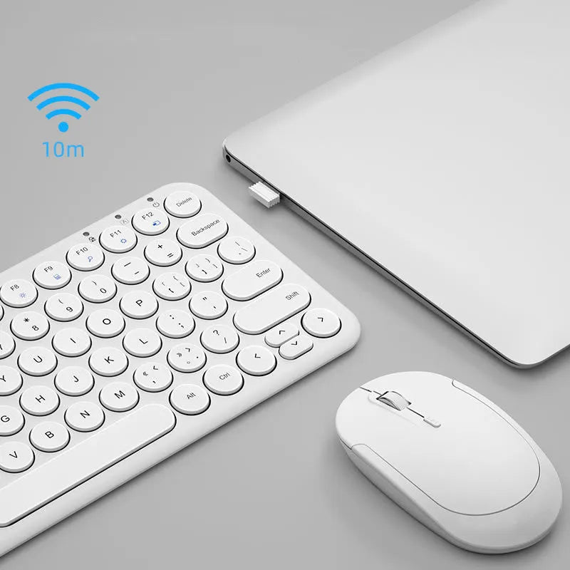 White ultra-thin wireless keyboard and mouse set with a single USB receiver on a wooden desk.