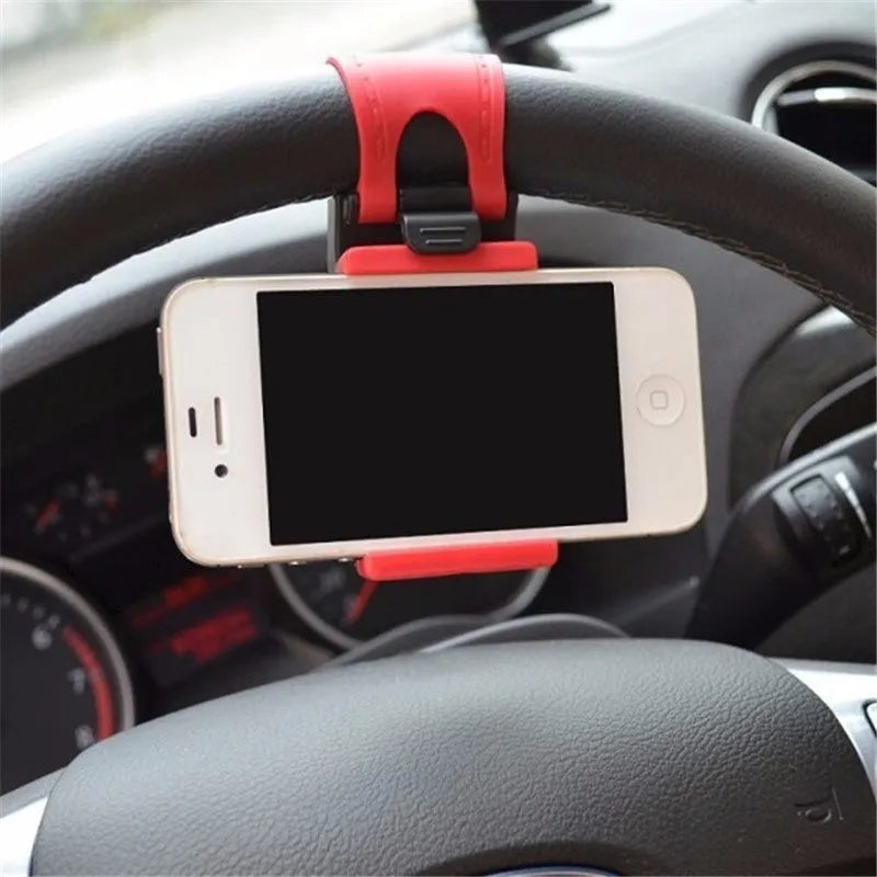 Black universal steering wheel phone clip holder with silicone pad mounted on a car steering wheel.