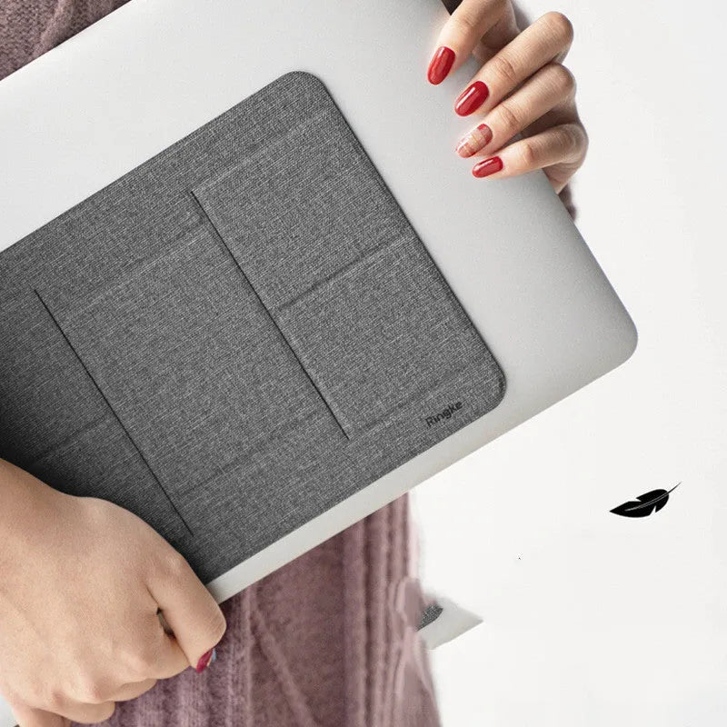 Ringke Folding Stand2 portable laptop stand in grey, folded open with a notebook placed on top