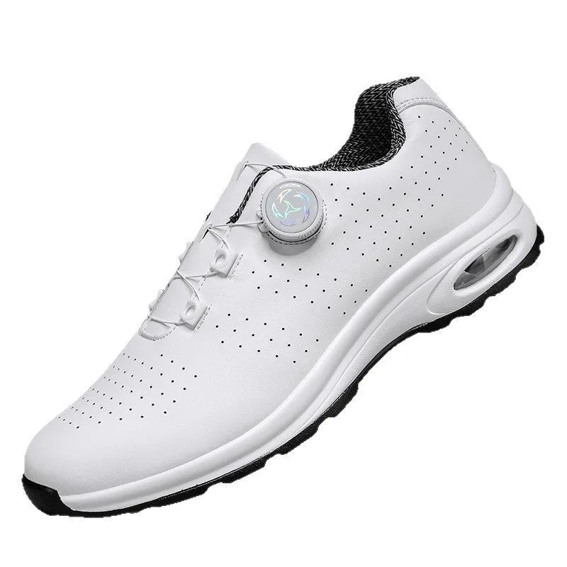 Black and white low-top tennis shoes with mesh upper and cross-shoulder straps on a composite sole.
