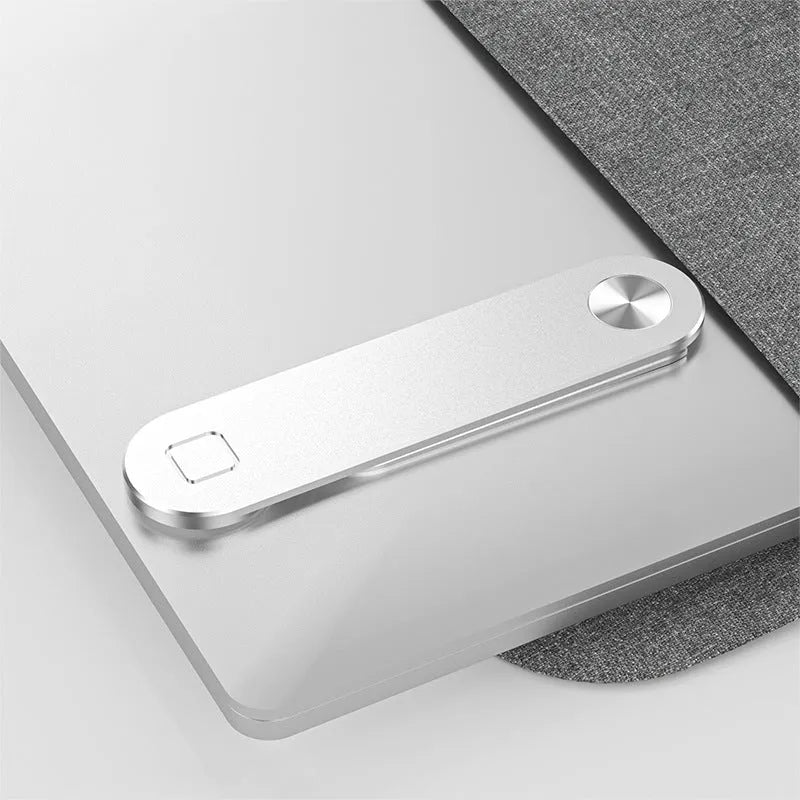 Black aluminium magnetic phone holder clipped to side of a silver laptop.