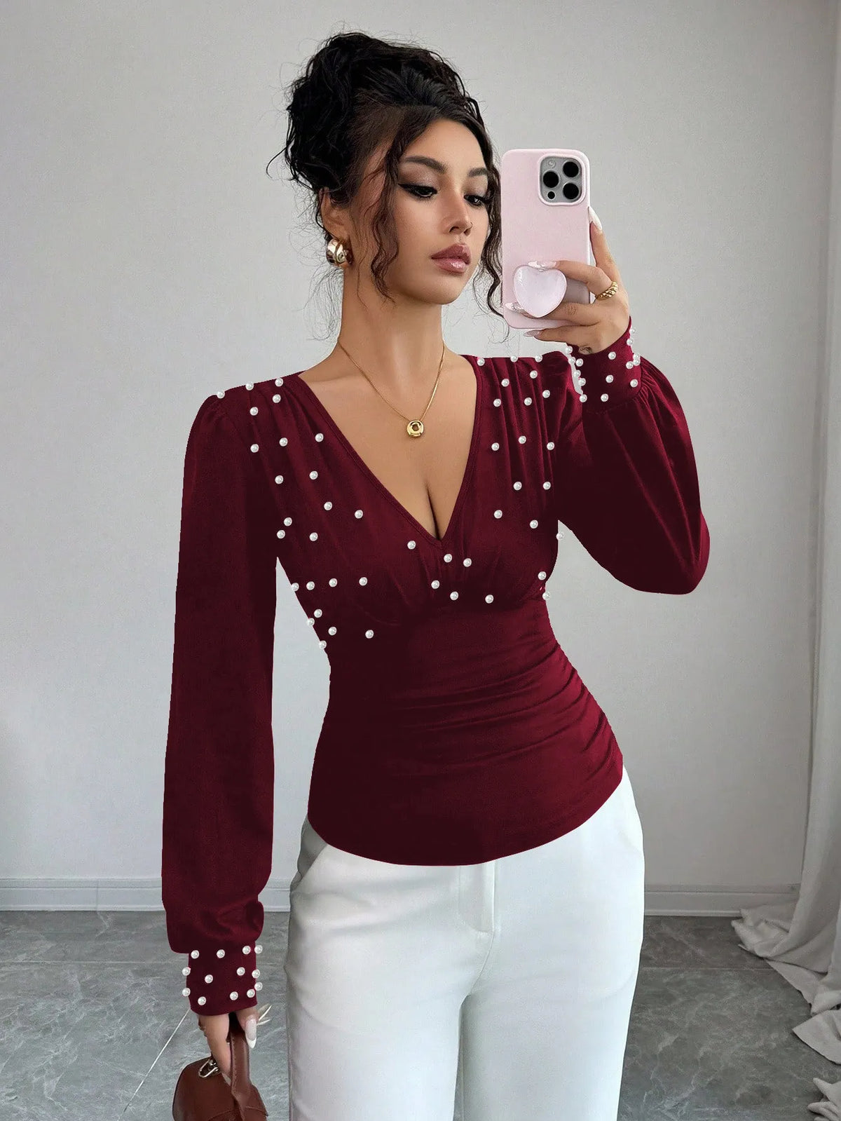 Women's V-neck solid colour fitted t-shirt with long bell sleeves in black, wine red, or apricot.