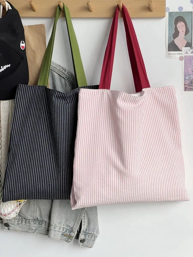Cotton canvas multi-layer tote shoulder bag in plaid or striped pattern options with wide straps.