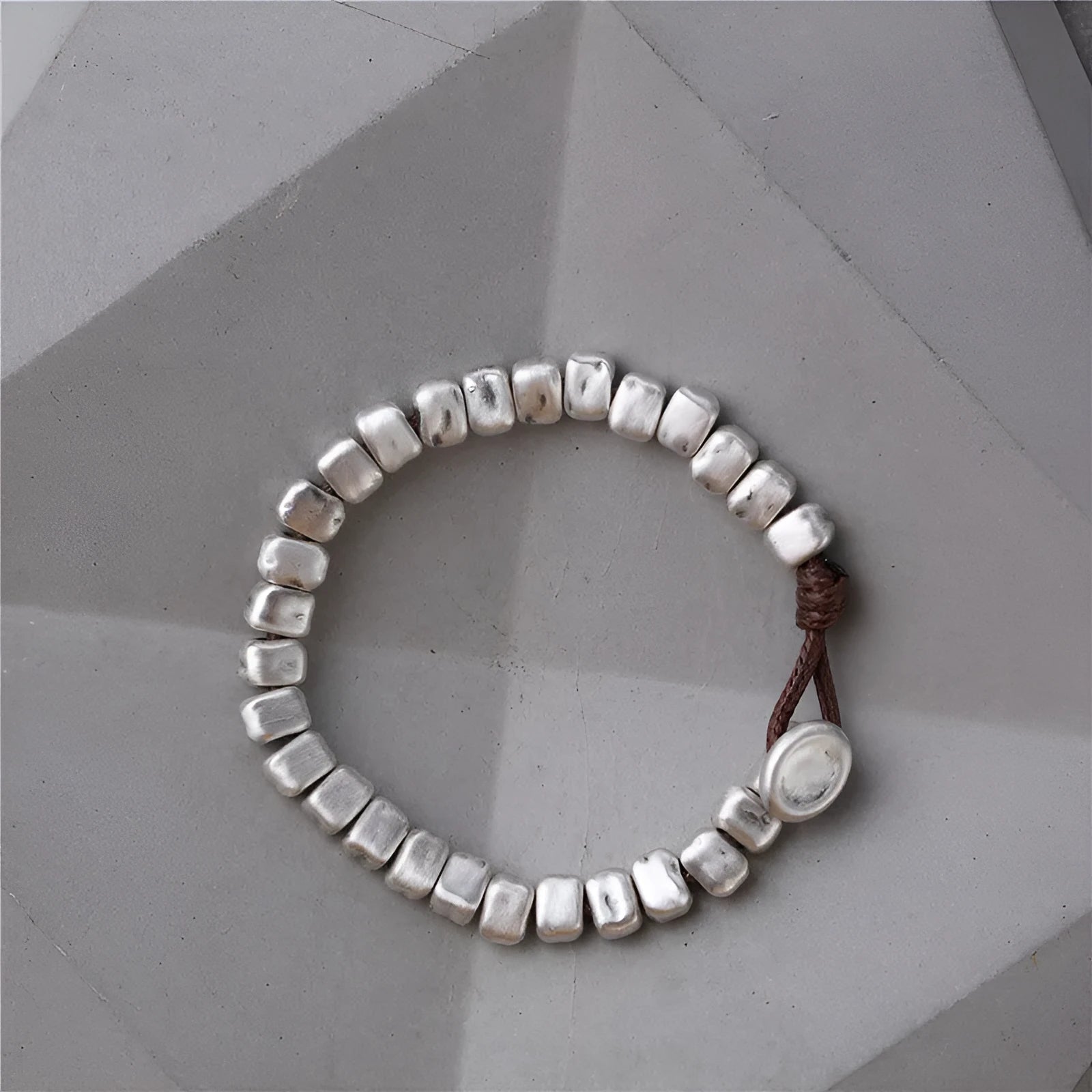 Handmade women's bracelet with irregular silver square and wood on a black elastic band.