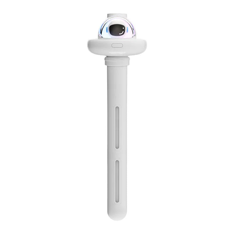 Small white plastic astronaut humidifier with USB cable on desk