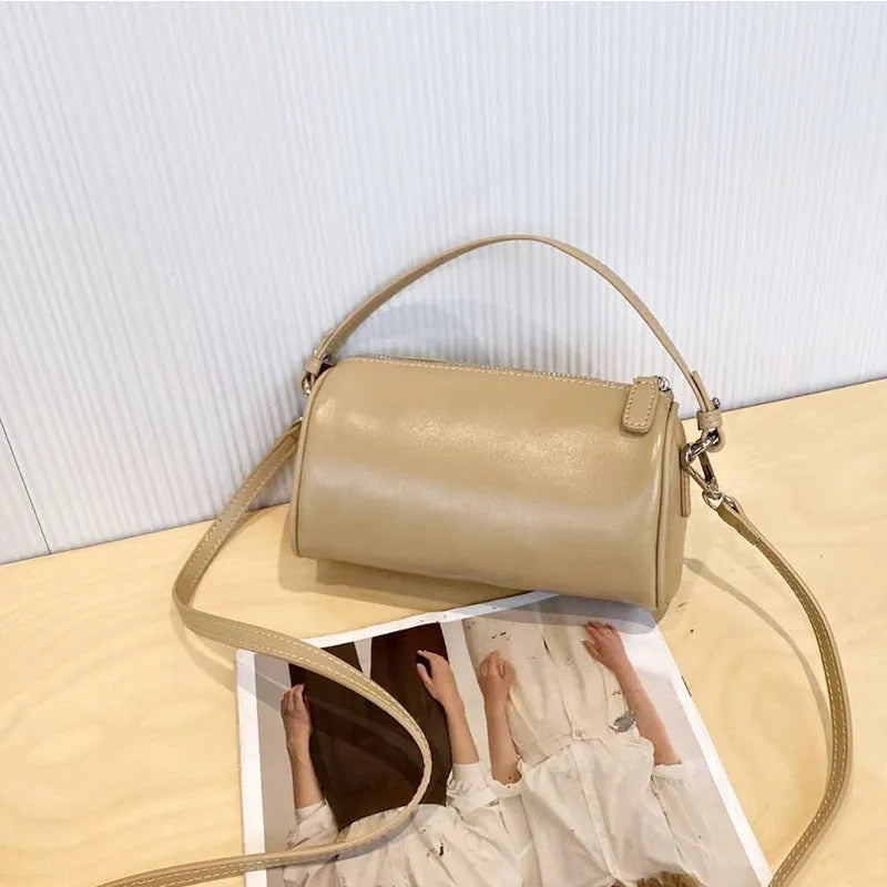 Genuine leather mobile phone crossbody bag with cylindrical design in six colour options showing sewing thread detailing