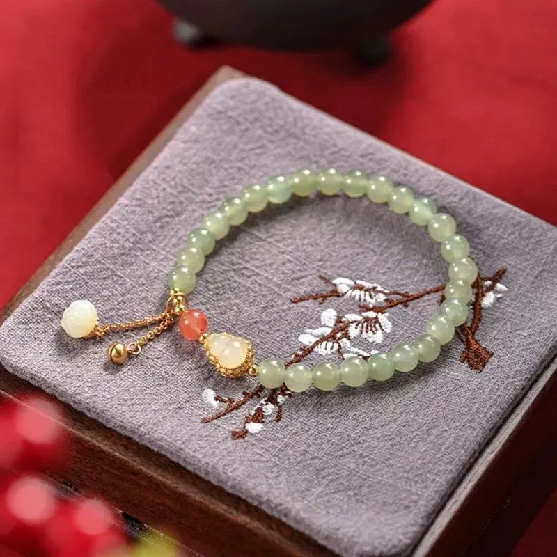 Jade and gold plated women's bracelet with fu character charm and Chinese knot fastening
