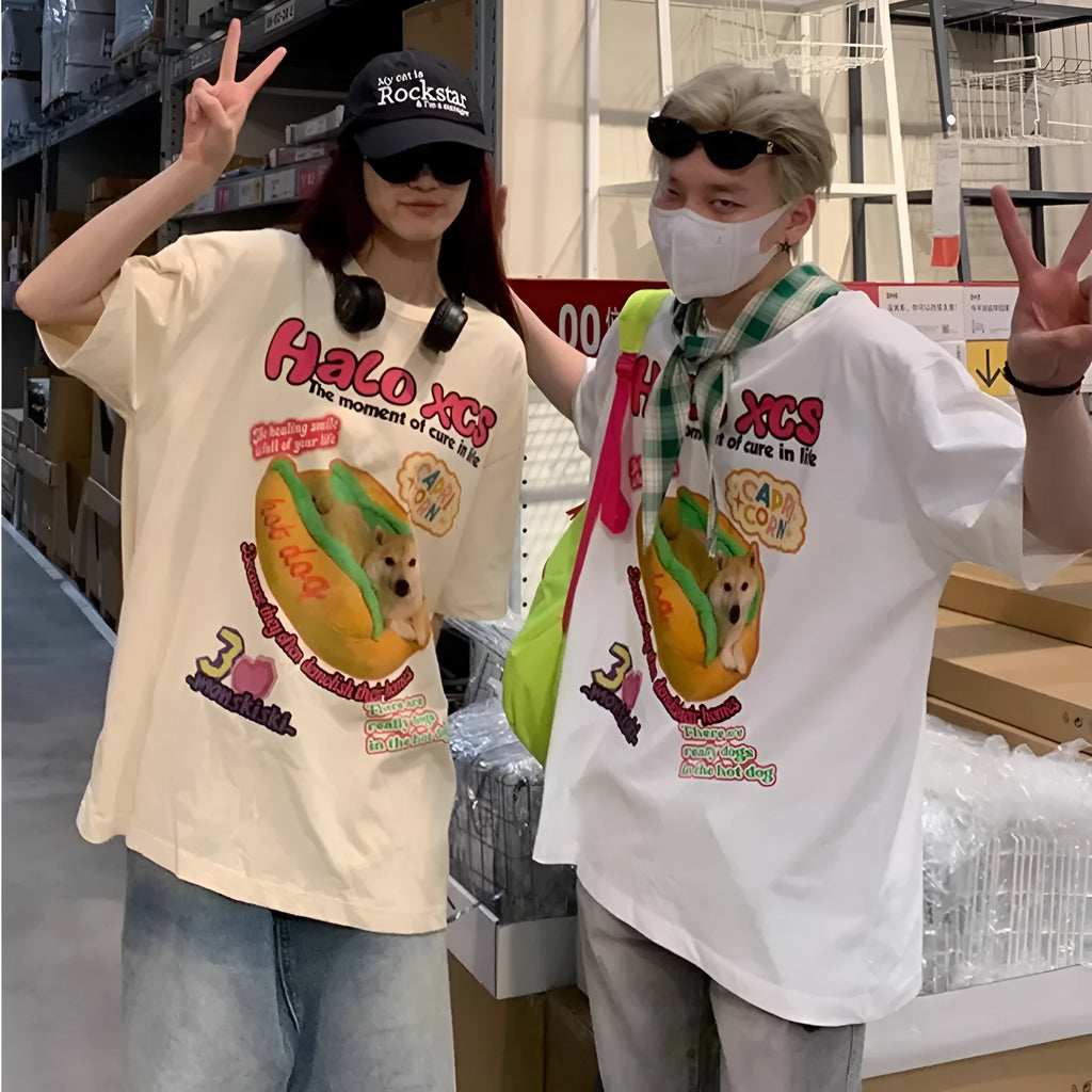 White loose cotton t-shirt with a cartoon print of a hamburger and a dog on the front.