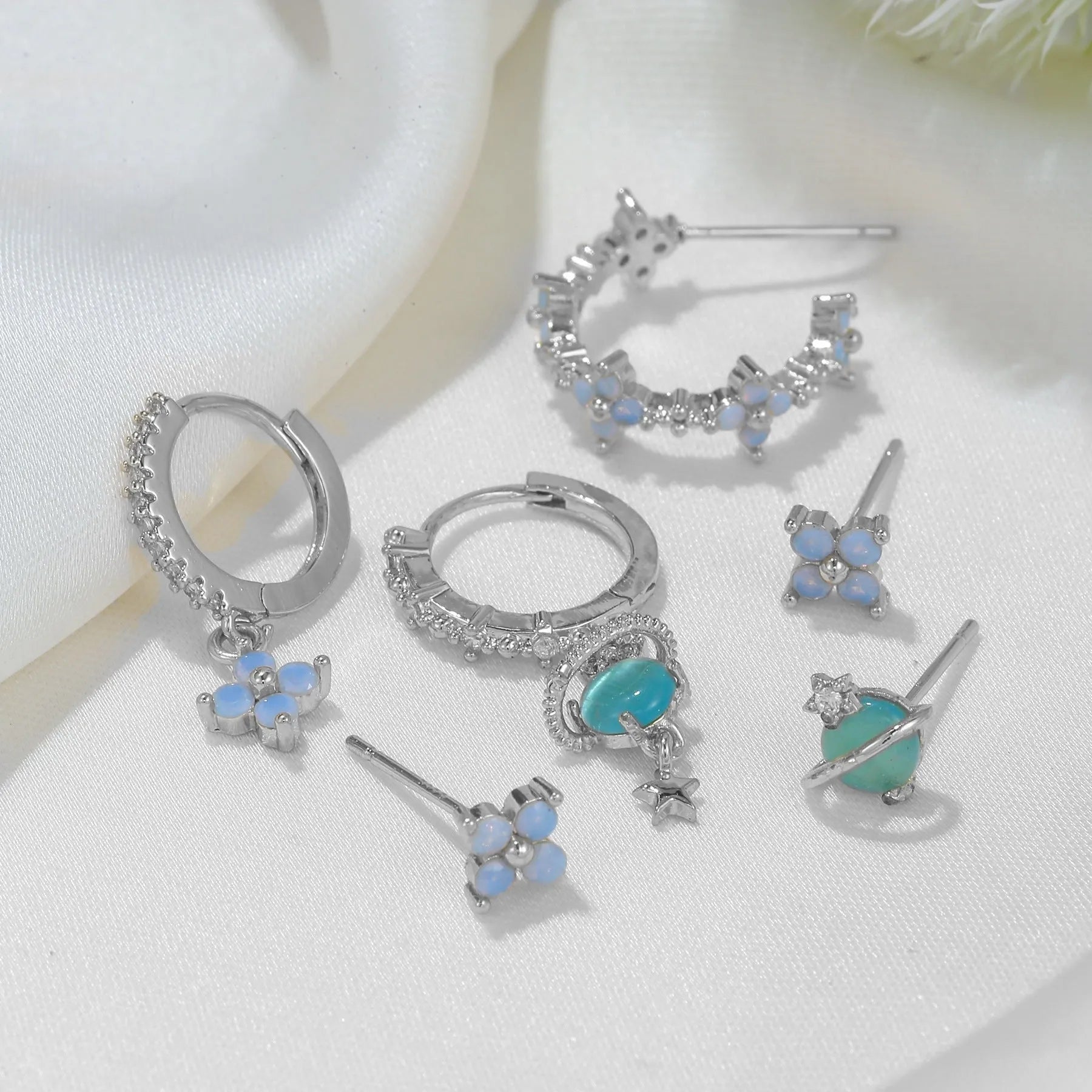 Gold and silver blue floral stud earrings with zircon mosaic on copper.